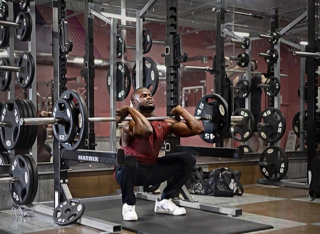 Coach Hamza in a front-rack squat position