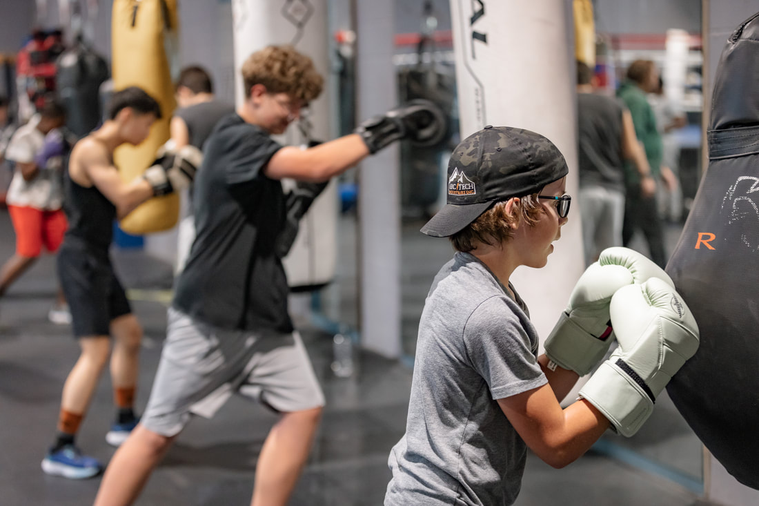 Kids boxing class on the heavy bags